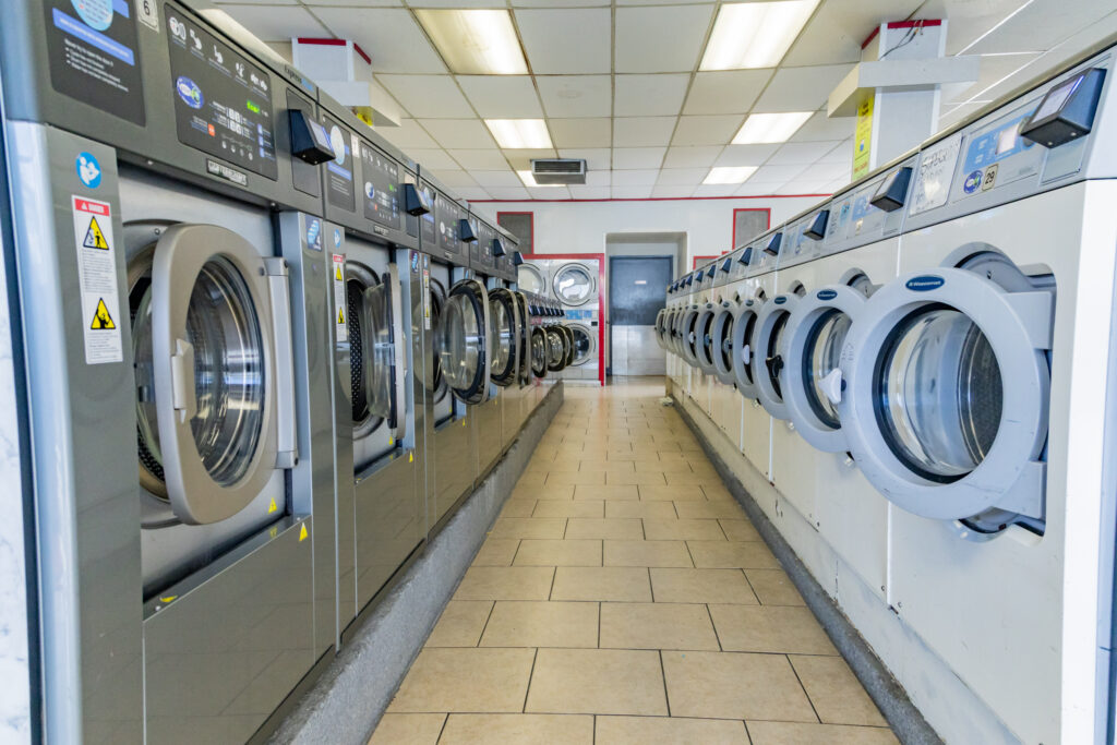 Interior of Super Suds laundromat with rows of washing machines